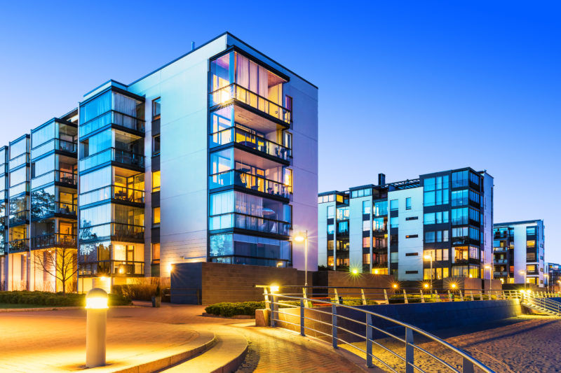 Outdoor urban view of homes with modern lighting.